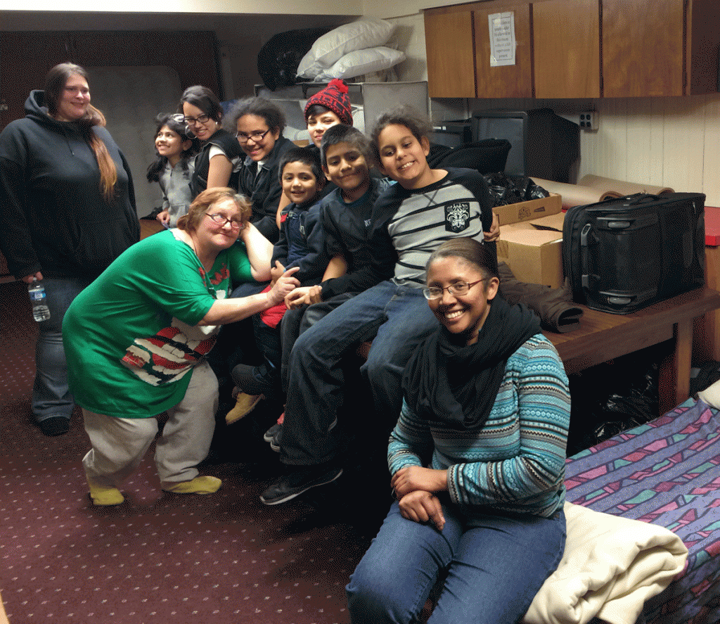 Donna Robinson of House of Divine Guidance (right) and several people staying at a shelter her organization operates for the homeless in the basement of the Sligo Seventh-Day Adventist Church on Carroll Avenue in Takoma Park, Md. (Mike Murillo/WTOP ) 