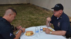 Claudio Consuegra, a member of the Beltsville Seventh-day Adventist Church and a volunteer chaplain with the Prince Georges County Police Department, shares the picnic with Corporal Elias of Beltsville Precinct #6.